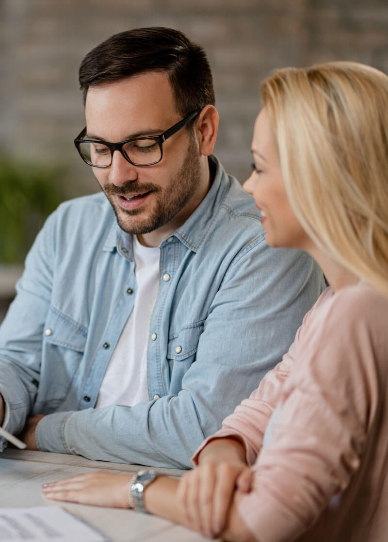 happy-man-his-wife-using-digital-tablet-while-being-meeting-with-bank-manager-office